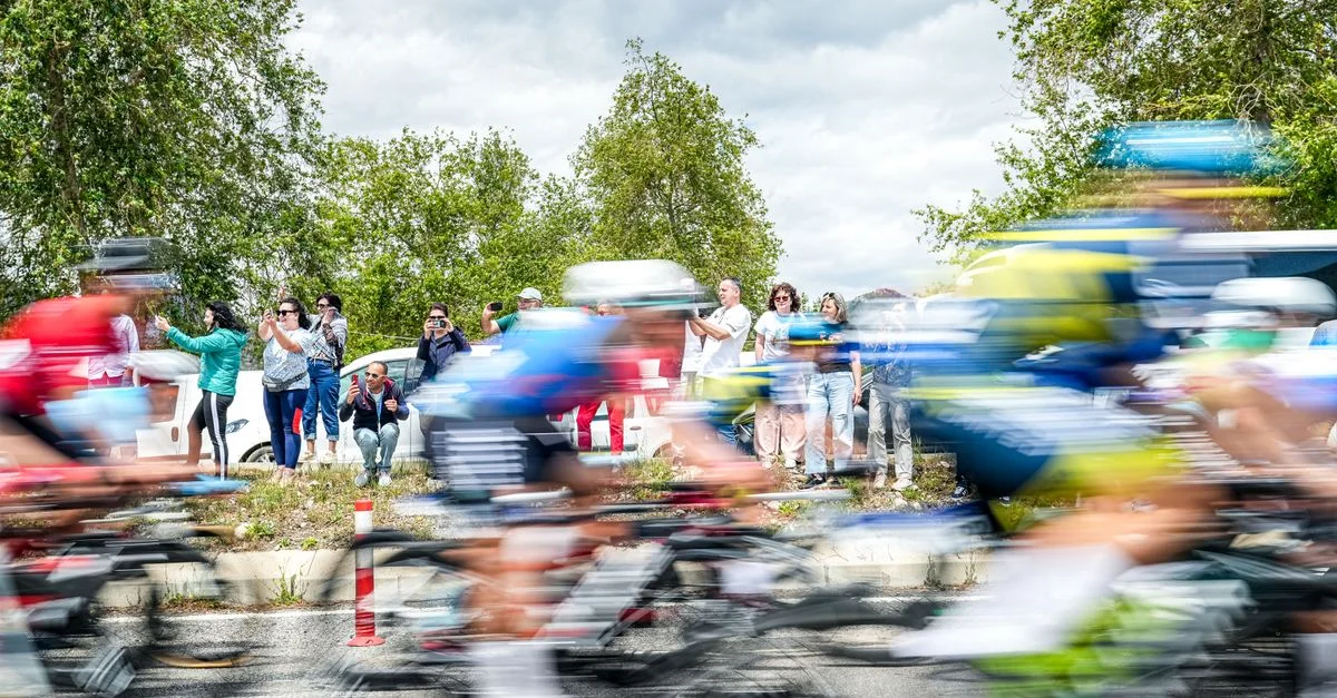 Cyclistes flous en course avec des spectateurs à Mersin, Turquie lors d'un événement diurne vibrant.